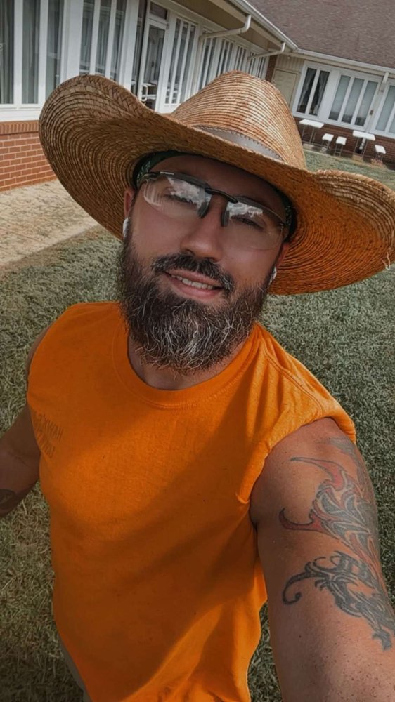 Chris Hawkins, owner of Hawk's Nest Lawn Care, on the job